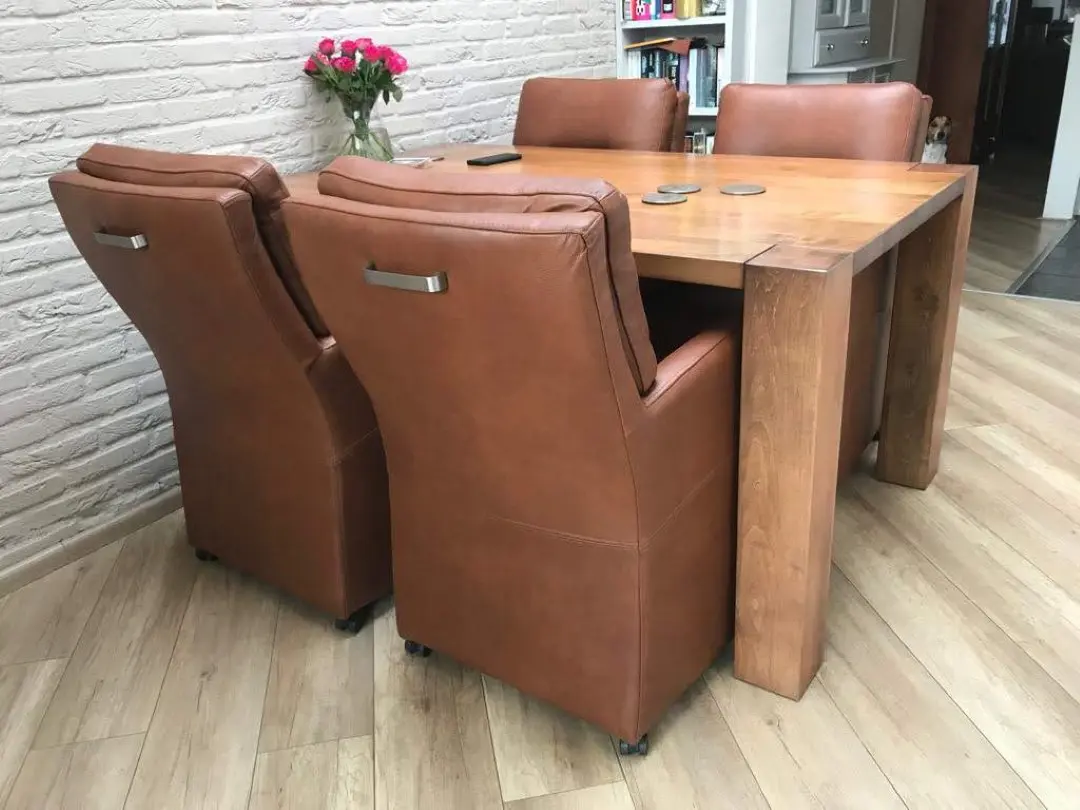 afbeelding van 4 leren eetkamerfauteuils - met armleuning en wieltjes - bruin leer