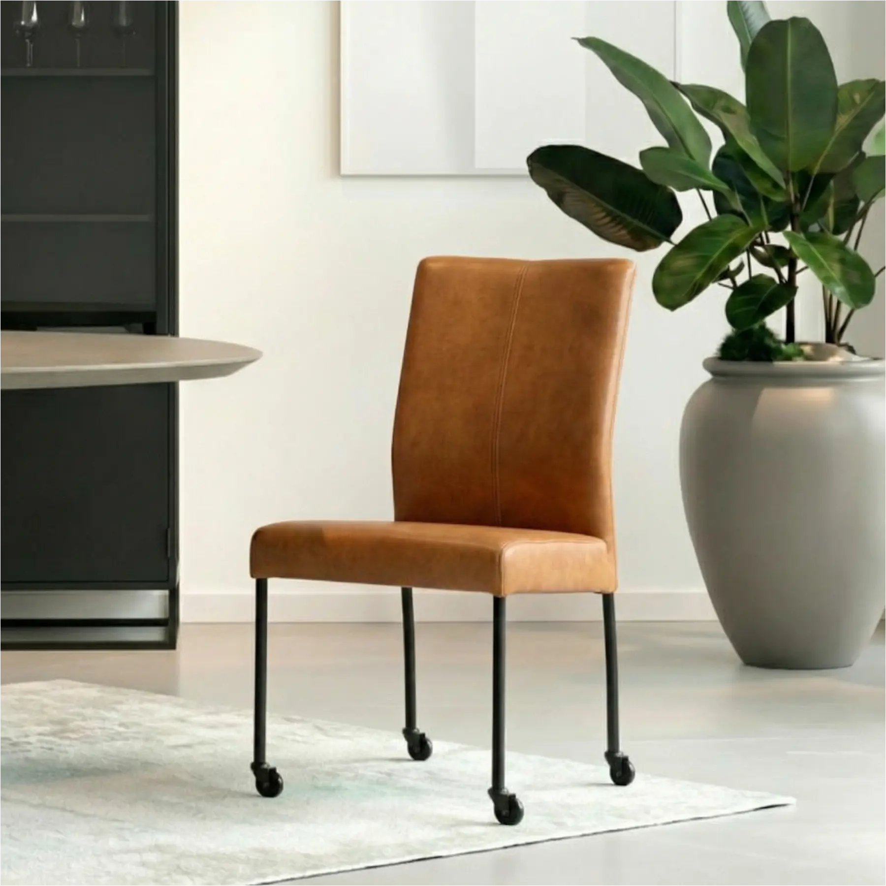 afbeelding van Leren eetkamerstoel Comfort met wieltjes - Granada Sahara (cognac) - Poten staal rond zwart
