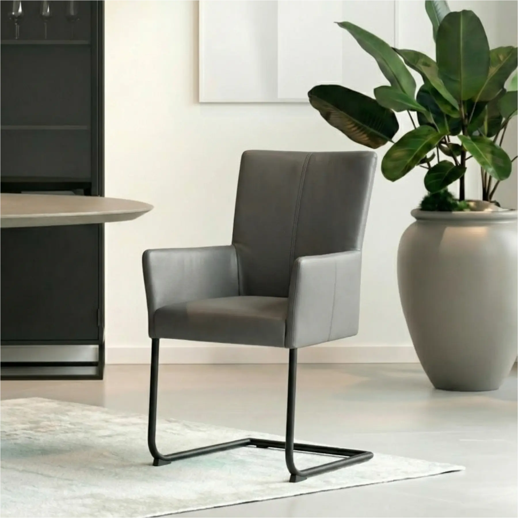 afbeelding van Leren eetkamerstoel Dry met armleuning - Toledo Antracite (donkergrijs) - Sledepoot staal rond zwart