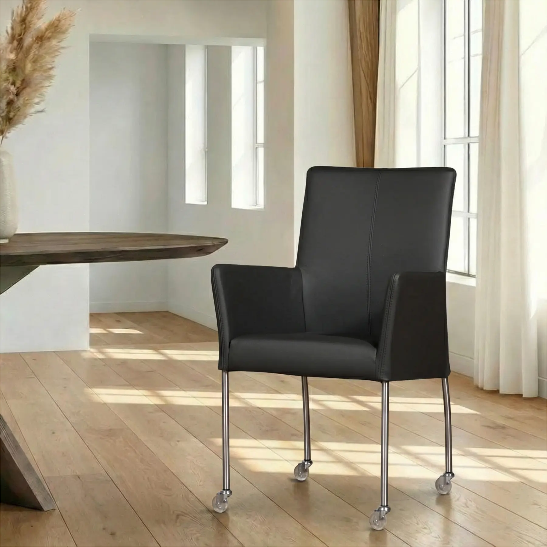 afbeelding van Leren eetkamerstoel Comfort met wieltjes en armleuning - Hermes Antracite (donkergrijs) - Poten staal rond RVS